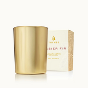 Gold candle and its packaging on a white background